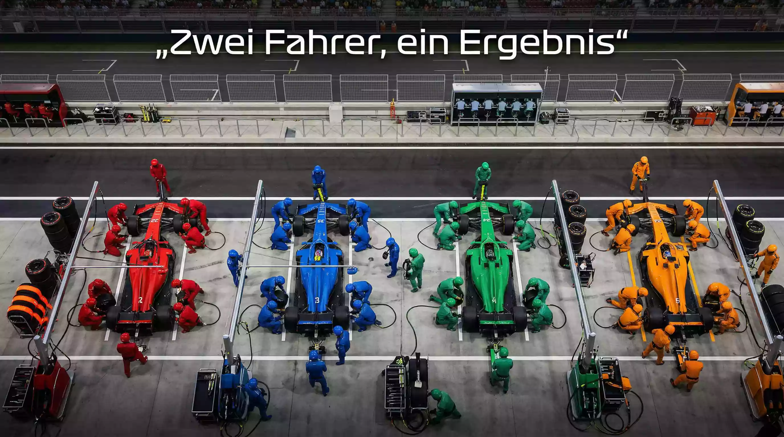 Formel-1-Boxengasse mit mehreren Teams bei der Arbeit an ihren Boliden – Konstrukteurs-WM